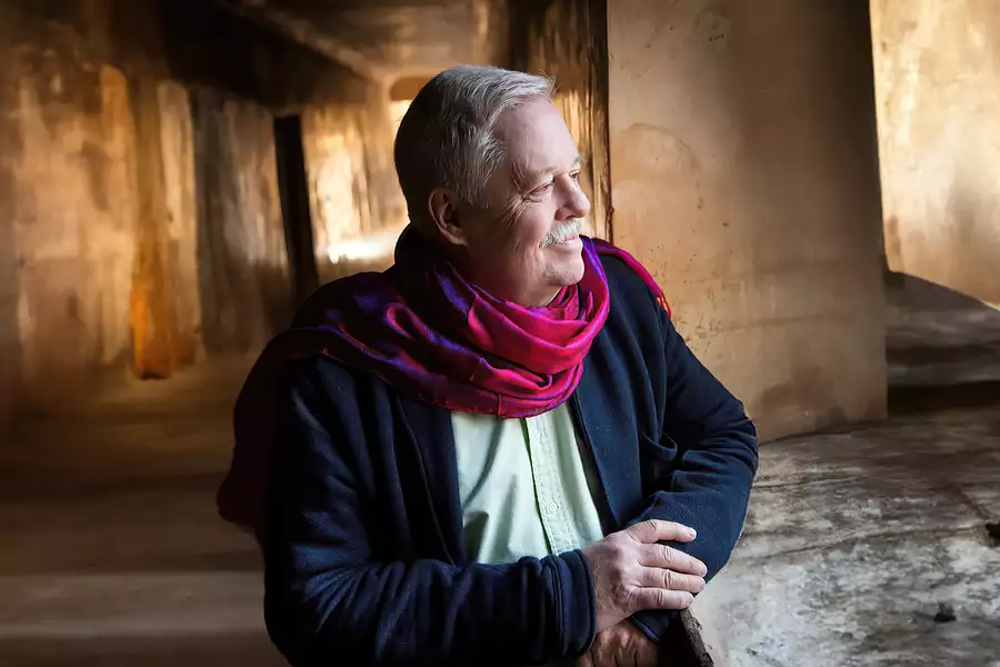 Armistead Maupin wearing a pink scarf