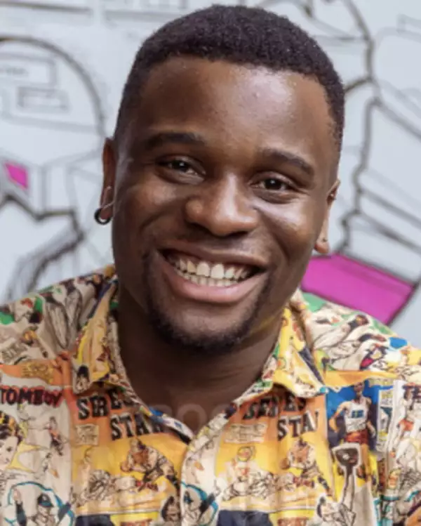 Headshot of Sonny Nwachukwu smiling, wearing a patterned shirt