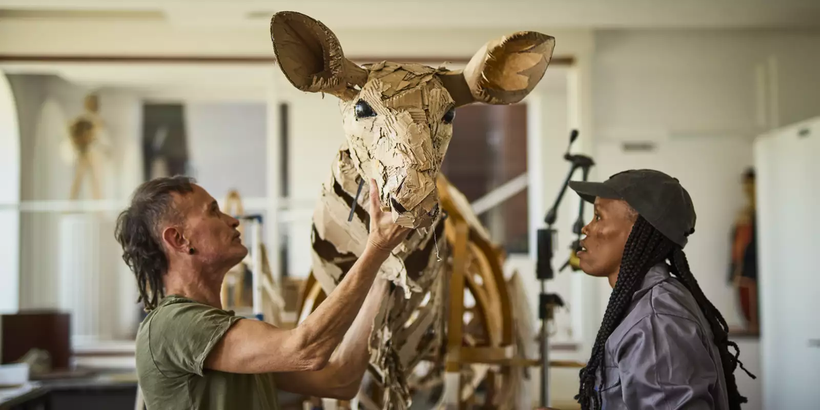 Life-sized puppet of a deer made of cardboard and metal