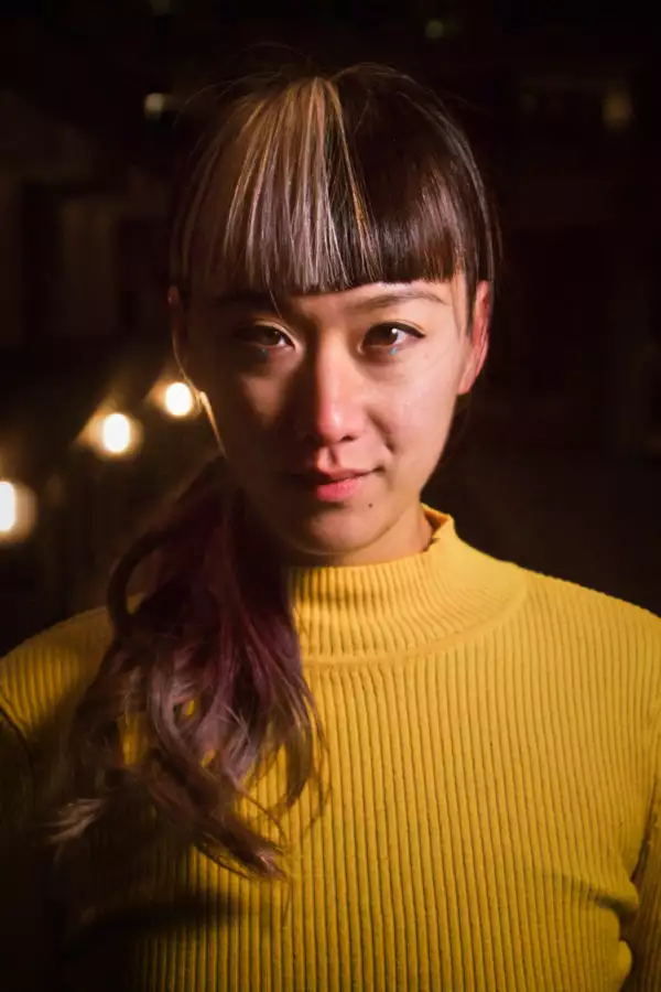 Headshot of Louiseanne Wong in a yellow jumper