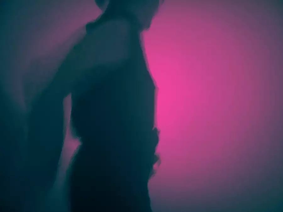 A silhouette of someone dancing in a club