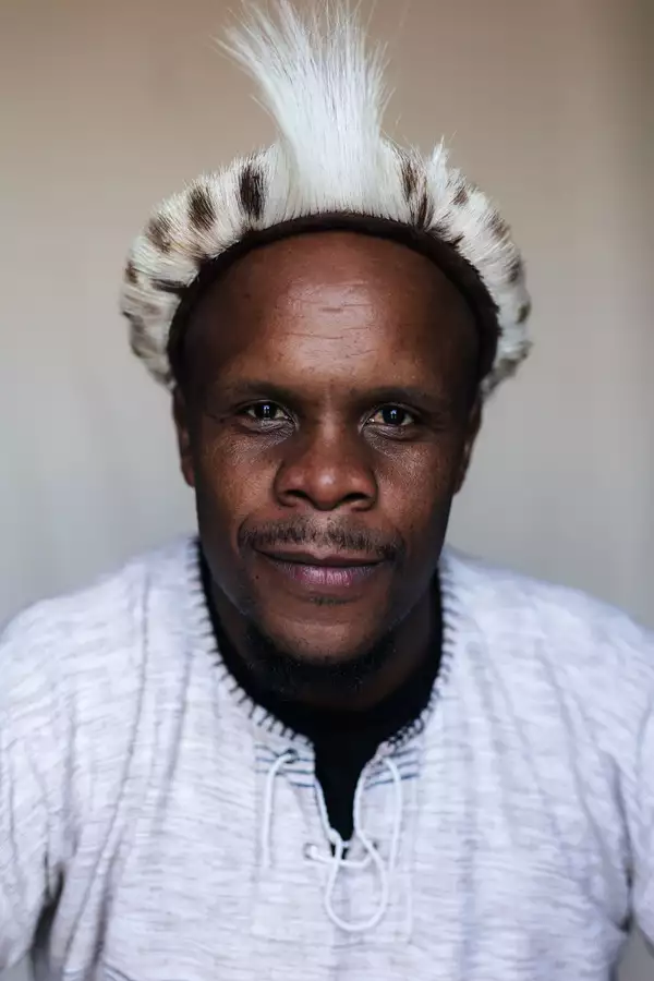 Thulani Zwane in a leopard print headband and grey top