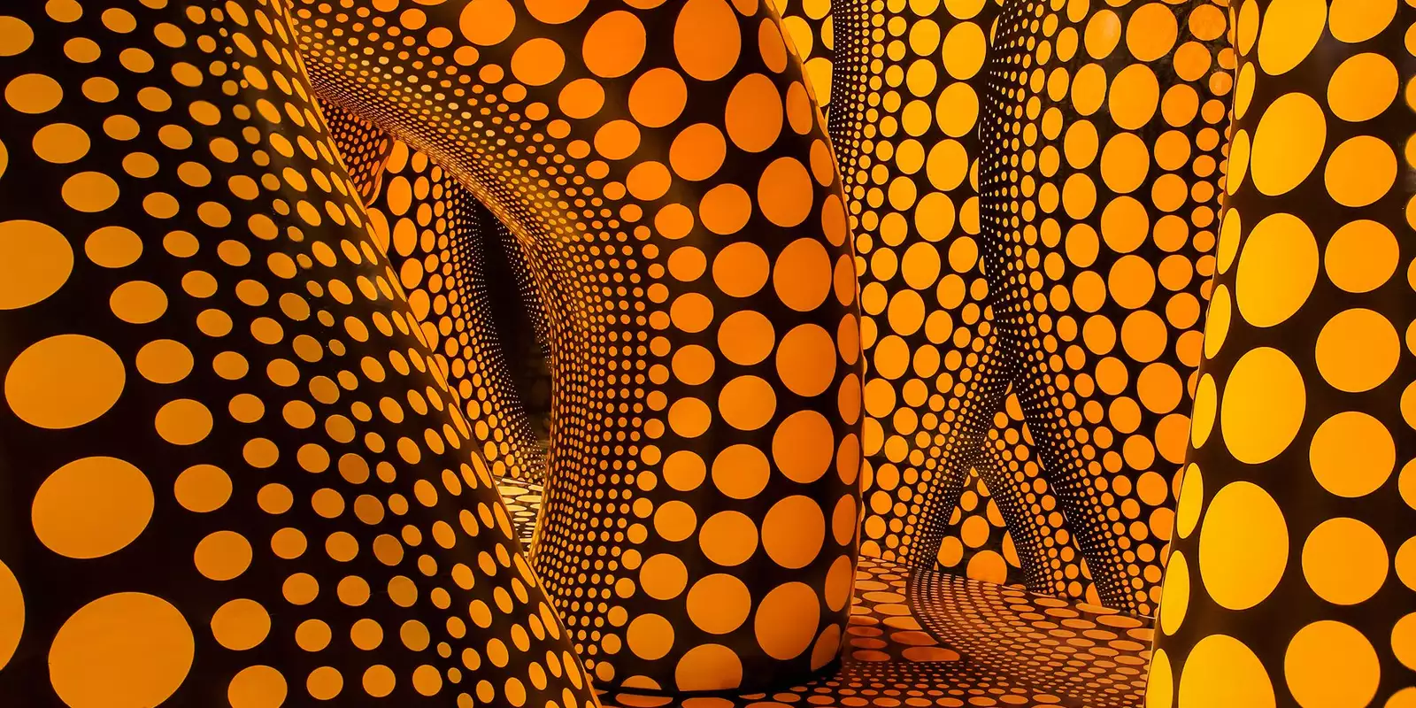 Yayoi Kusama artwork of large inflatable yellow tentacles with black polkadots on them