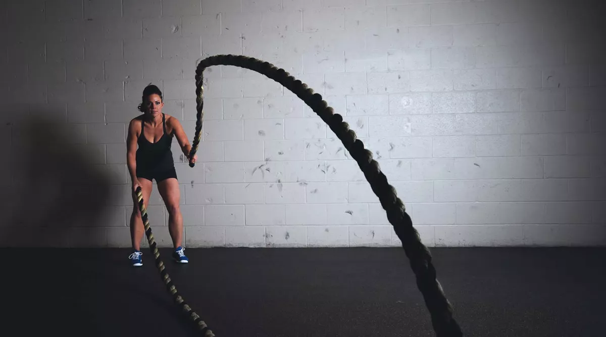 An athlete trains with heavy ropes