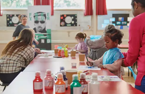 Photo of families painting together
