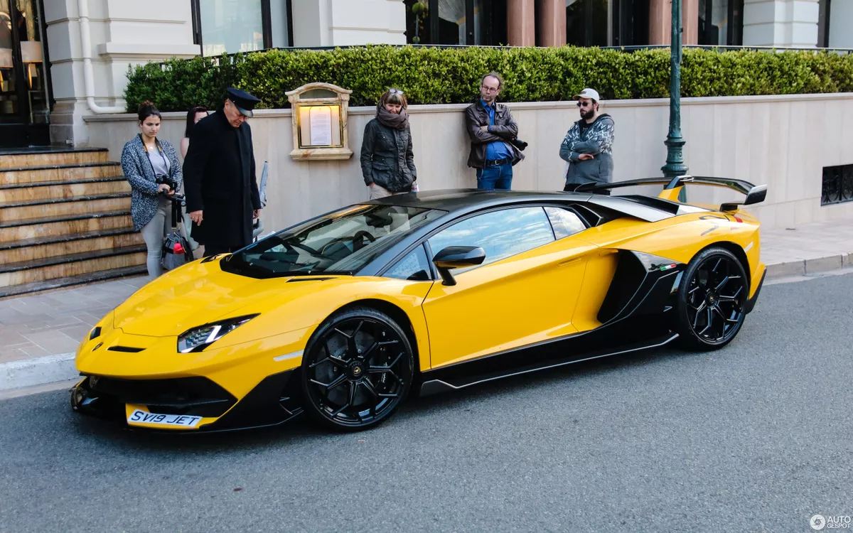 Lamborghini sports car parked, several onlookers