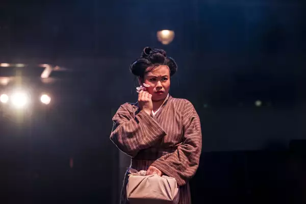Photo of Mei Mac holding a flower up to her face