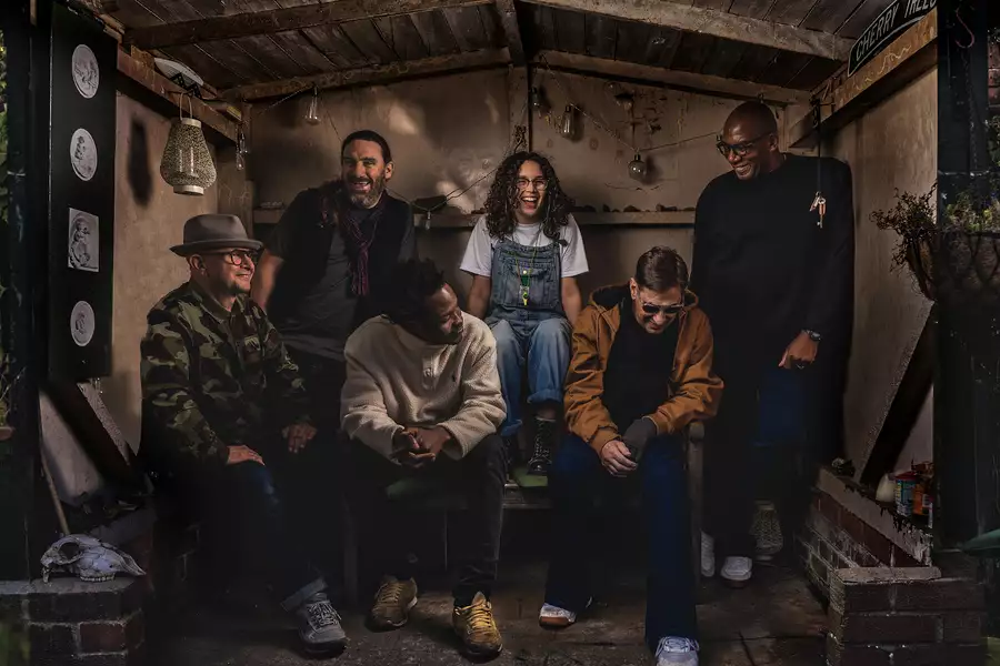 The band A Certain Ratio sitting in a garden shed