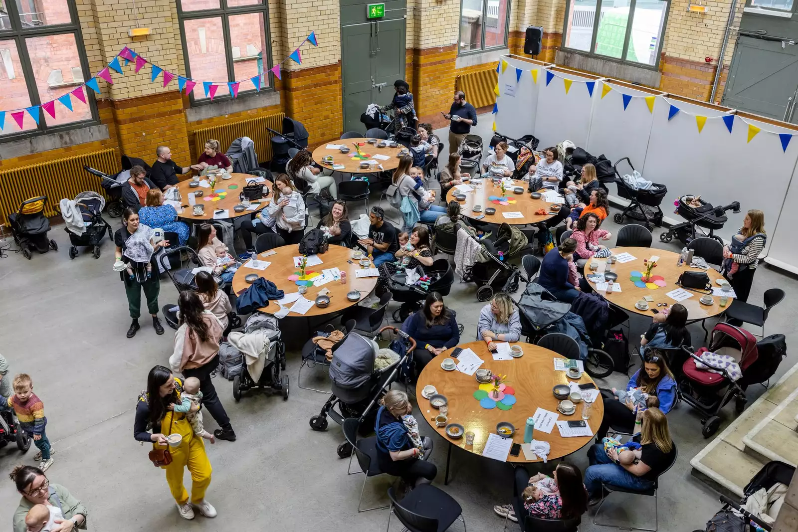 First breath families sat at round tables in a large, decorated hall