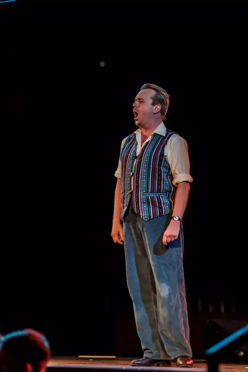 Photo of a man singing on stage