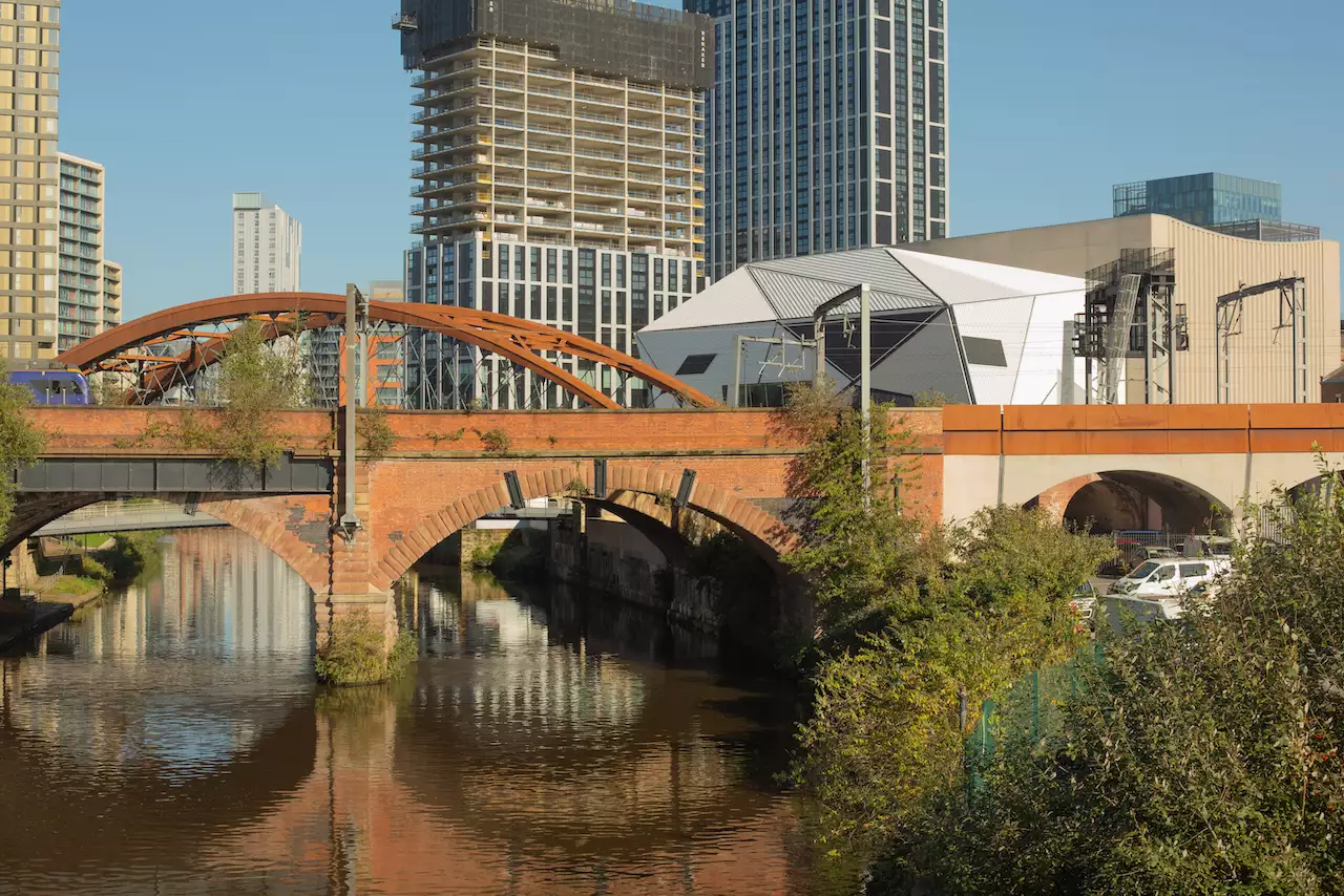 Photo of the city with the River Irwell, bridge and Aviva Studios