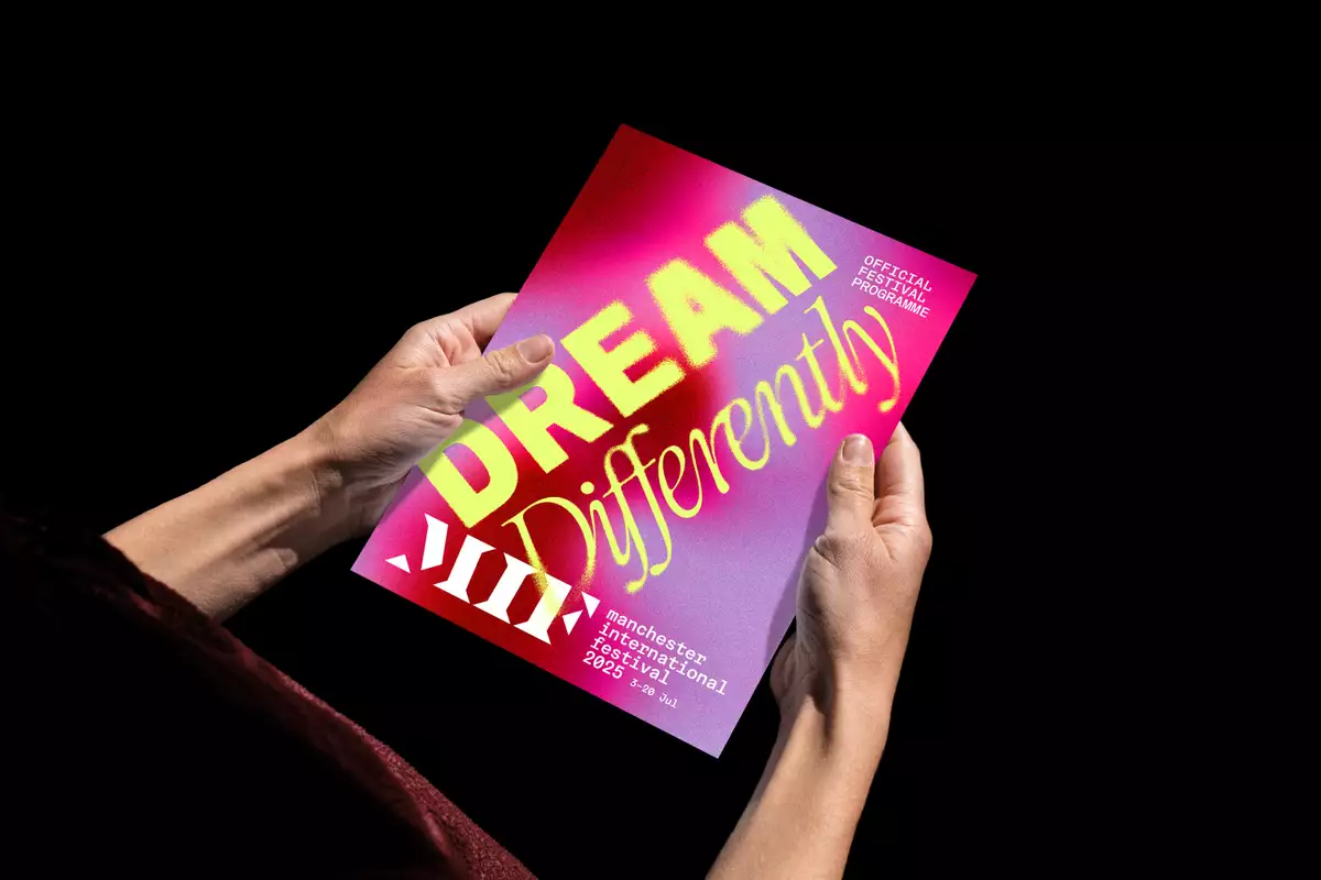 A person holding the MIF25 official programme.