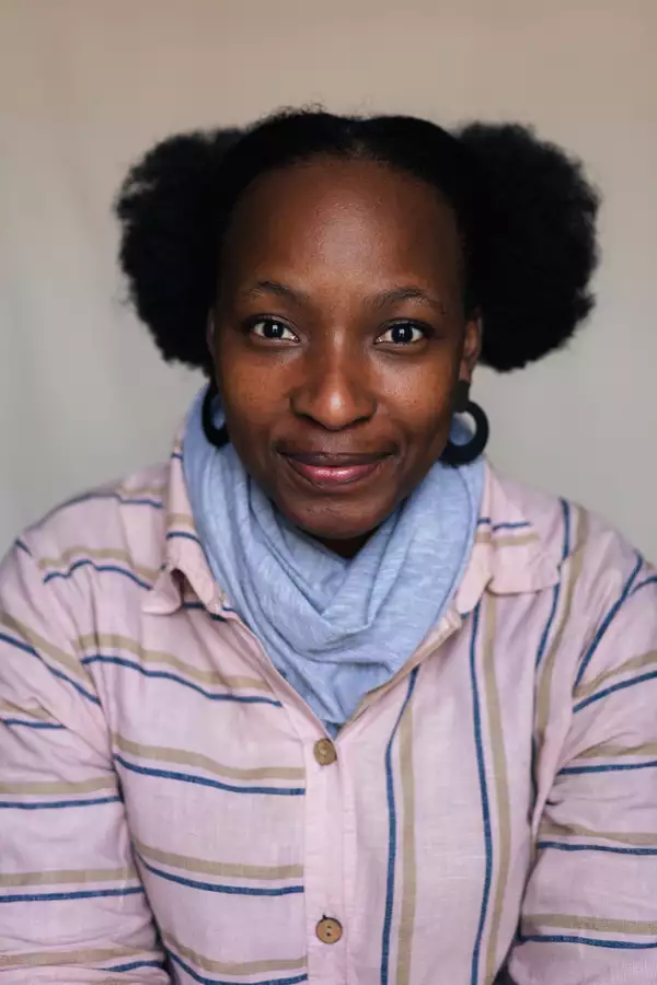 Barileng Malebye in a pink striped shirt and blue scarf