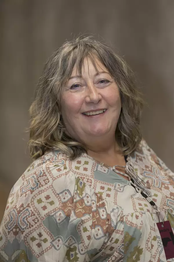 Portrait photograph of Clare Bayat wearing a patterned top