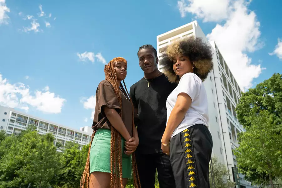 LIVE + BREATHE climate campaigners outside of a tower block with greenery in the background