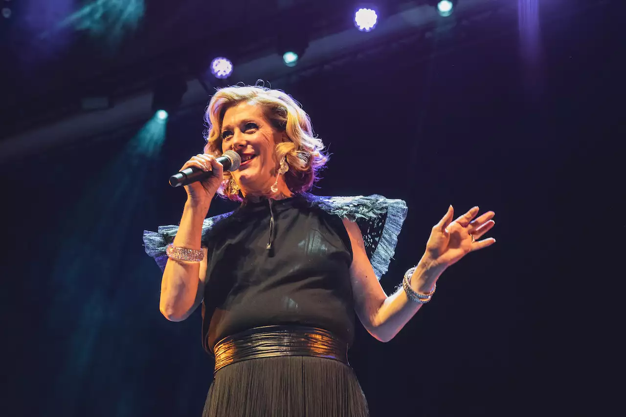 Close-up photo of Justin Vivian Bond with microphone