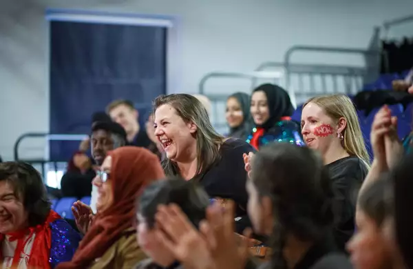 A crowd of people smiling and laughing