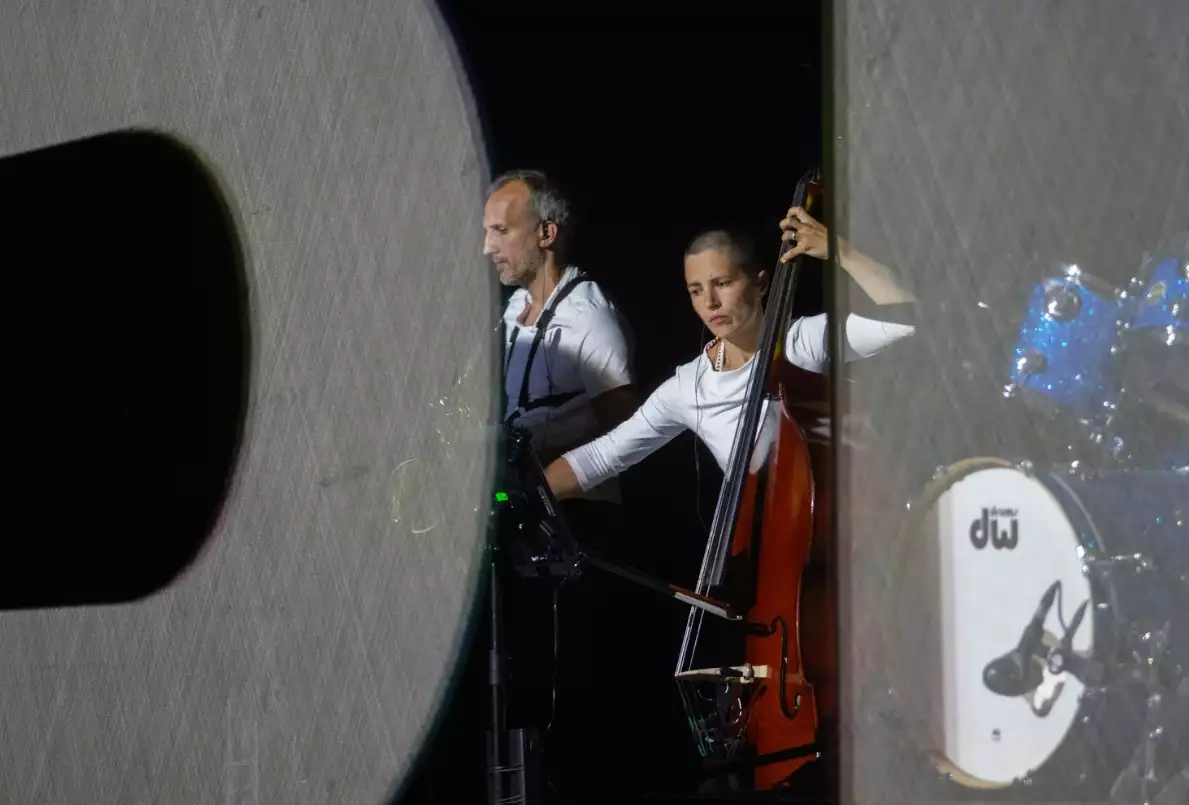 Photo of a two people playing a double bass and saxophone