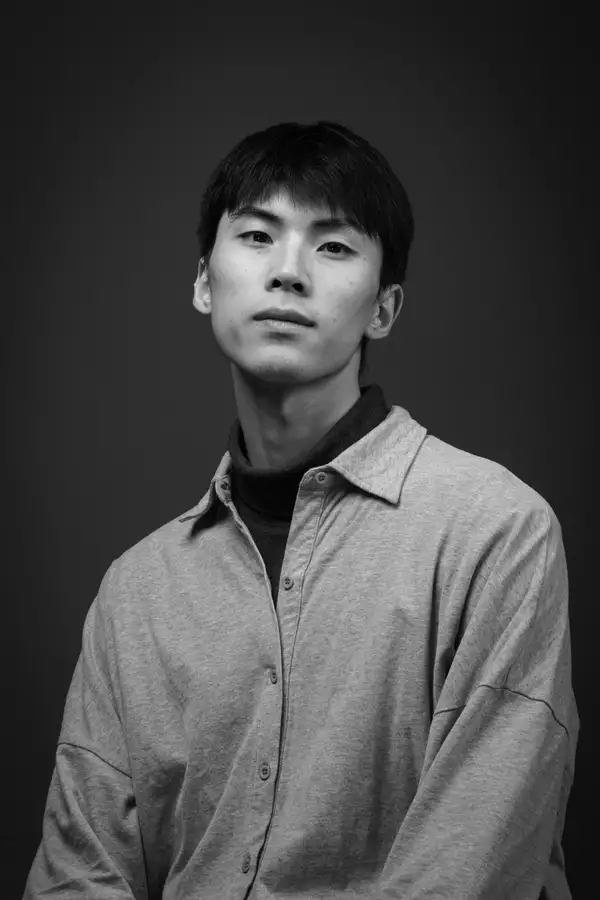 Black and white headshot of Junkai XU