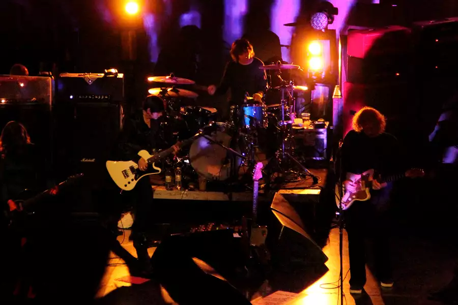 my bloody valentine perform live on a low lit stage