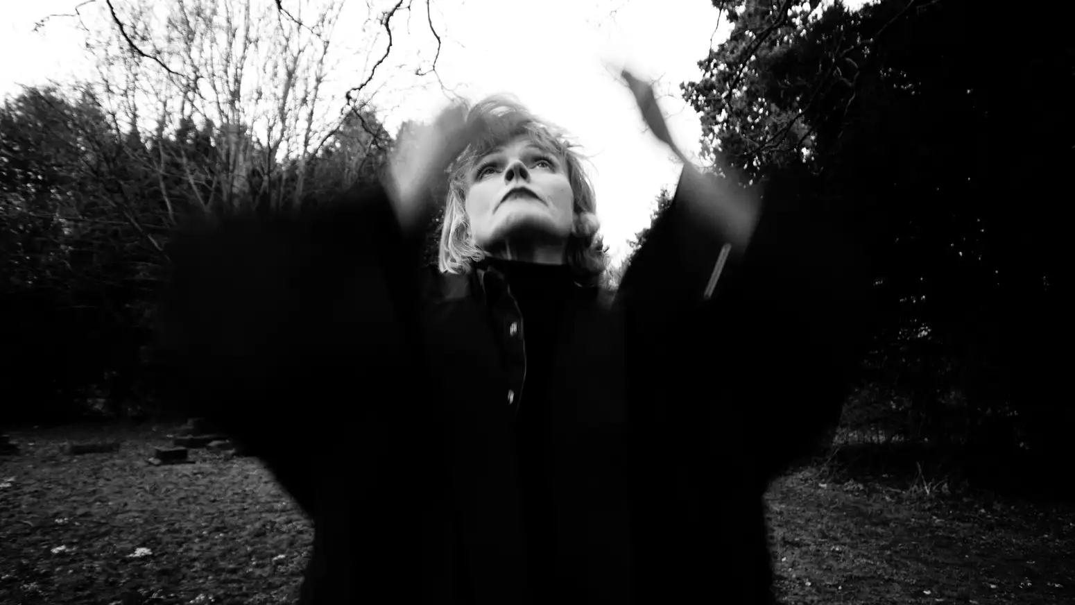 black and white, blurry photo of Maxine Peake looking up at the sky