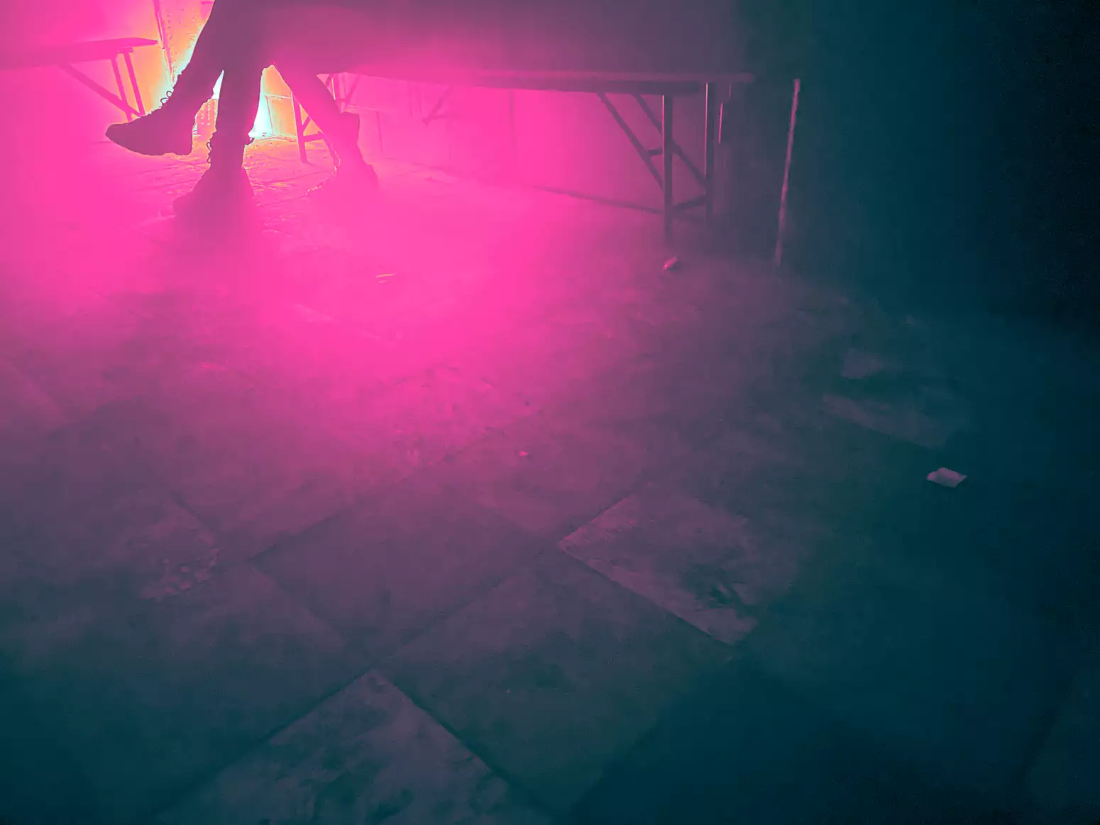 A person sits in the corner of a club