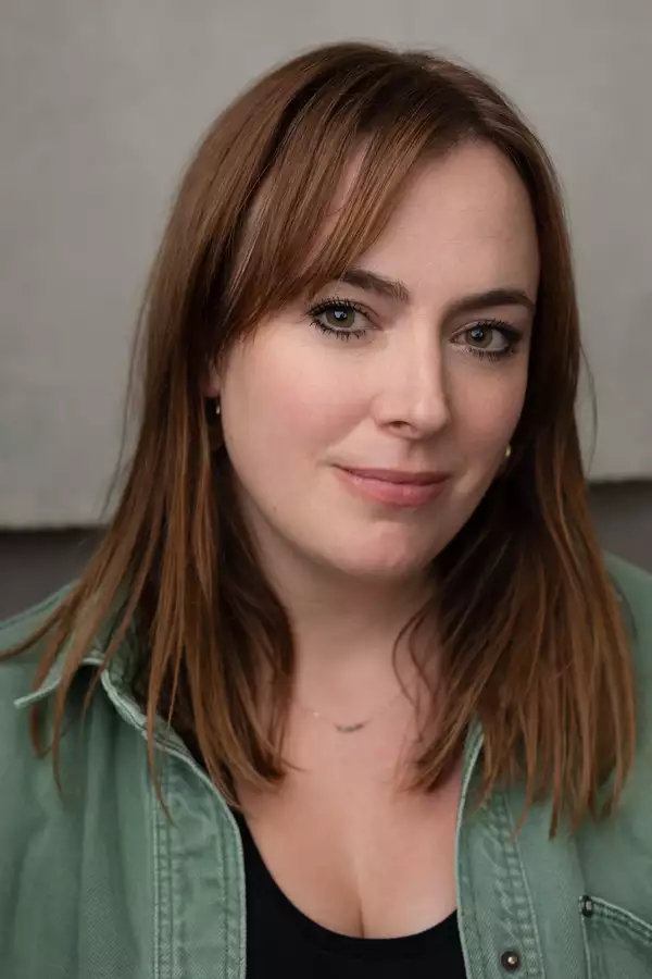 Jess Williams wearing a green shirt against a grey background