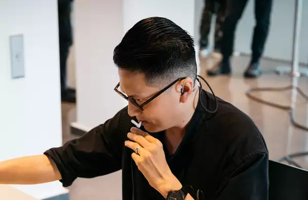 Samson Young in a black top looking to the left