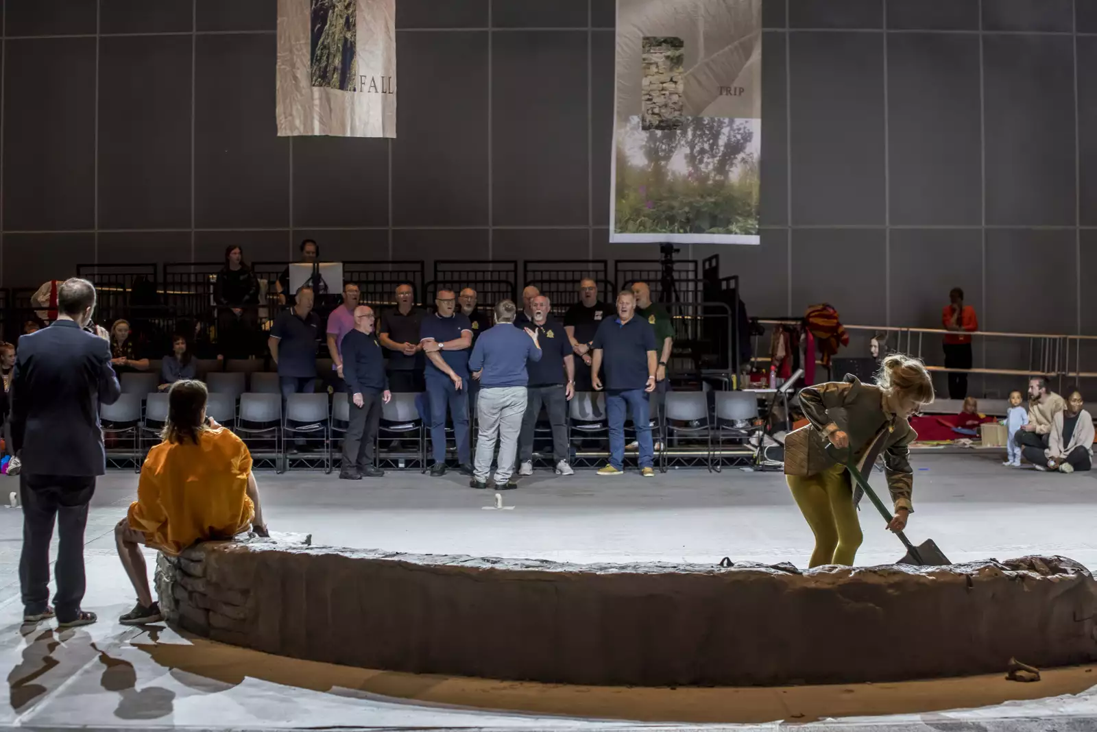Two people sat on the clay installation with another person digging – during the June 2024 Artist Takeover