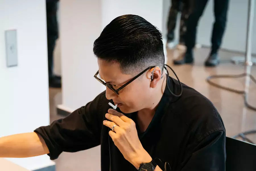 Samson Young in a black top looking to the left