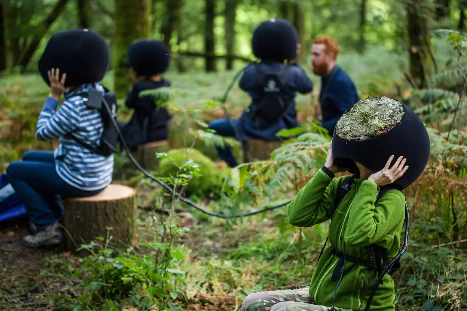 Children wear headsets in Grizedale Forest experiencing In The Eyes of The Animal by Marshmallow Laser Feast