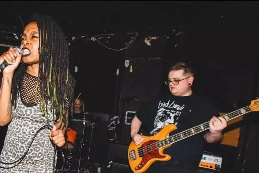 Photo of two members of Gurnal Gadafi performing on stage