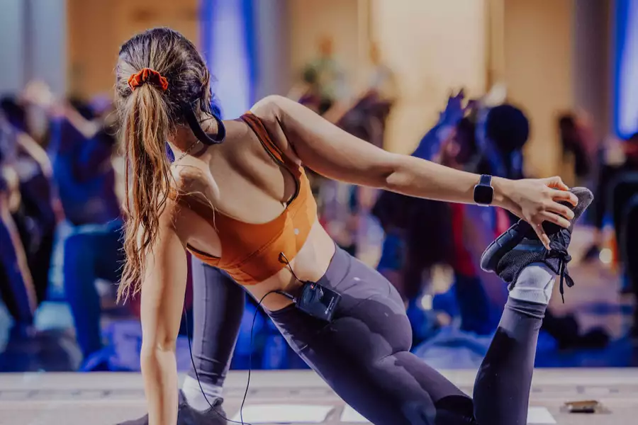 A person doing a yoga pose, leading a class