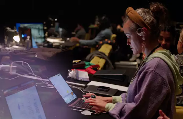 Writer Sabrina Mahfouz works on her laptop