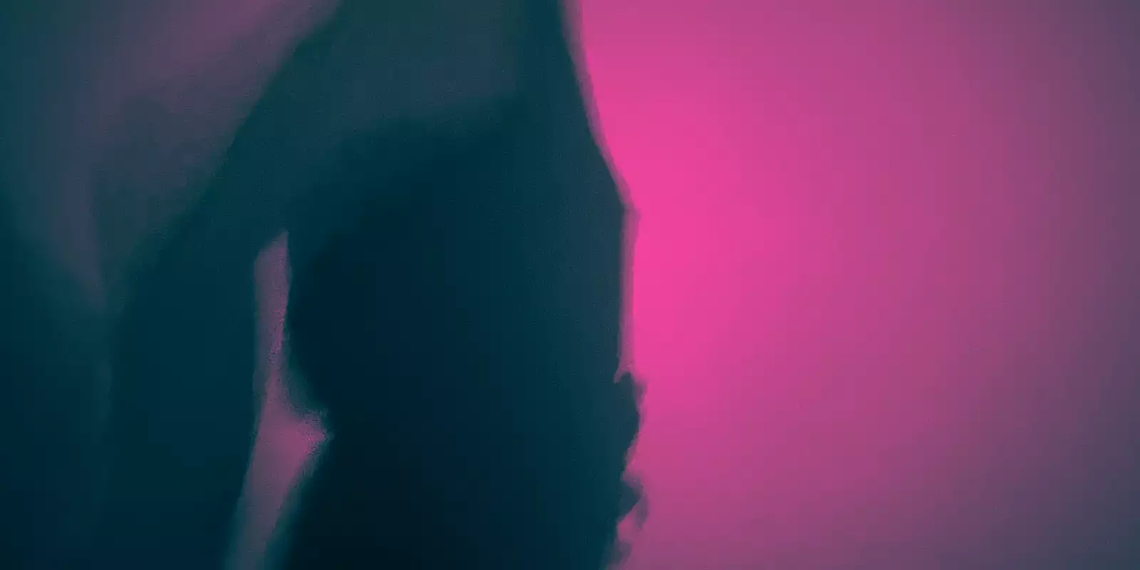 A silhouette of someone dancing in a club