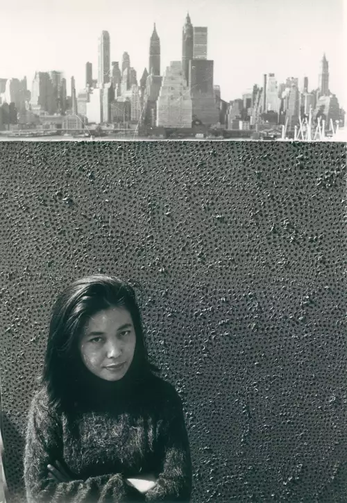 Yayoi Kusama with one of her Infinity Net paintings in New York