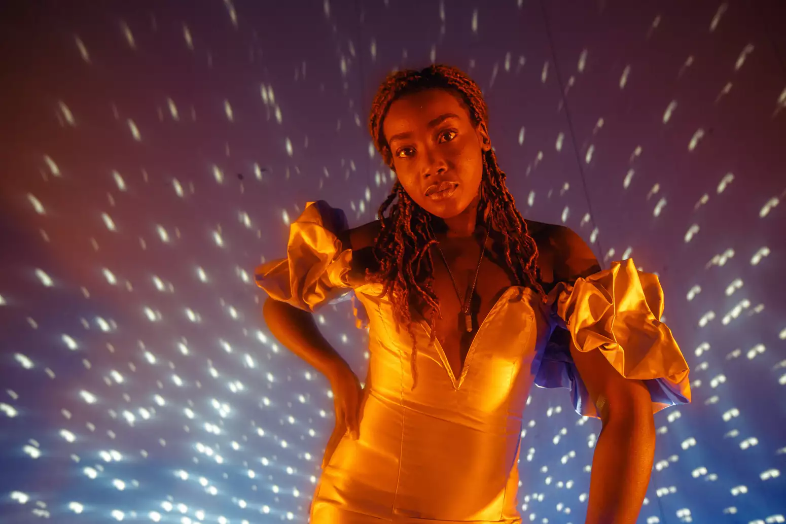 B!TEZ stands in front of a disco ball photographed by Marieke Macklon