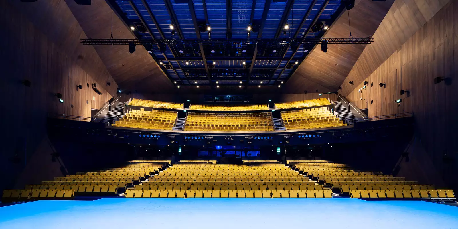 Photo of the stage and yellow seats in the Hall