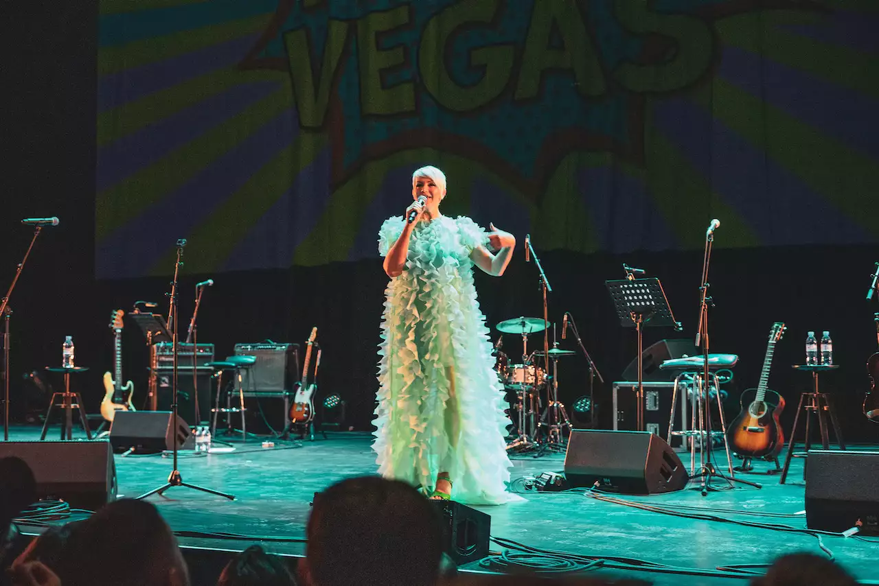 Photo of Kate O'Donnell on stage in a blue dress