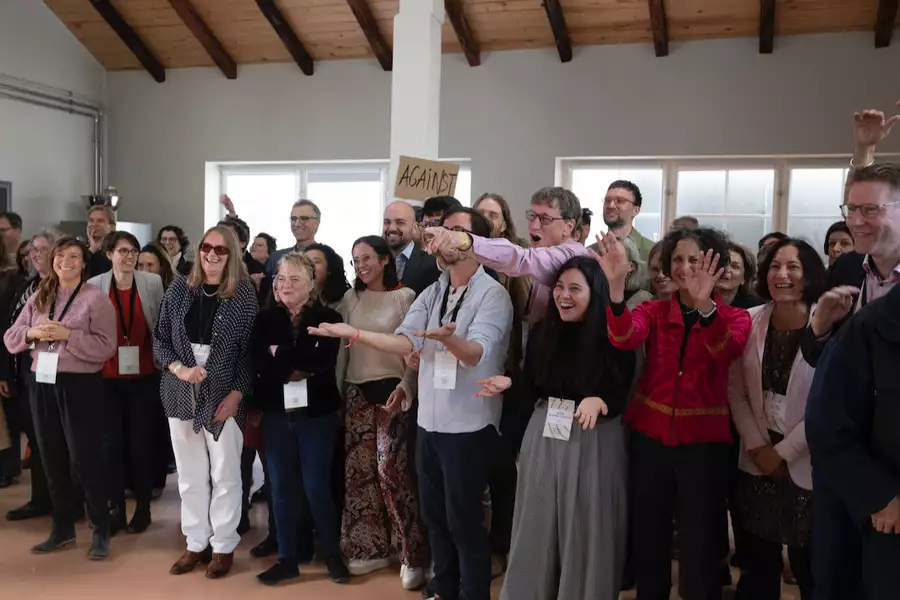 A large group of people stood up smiling