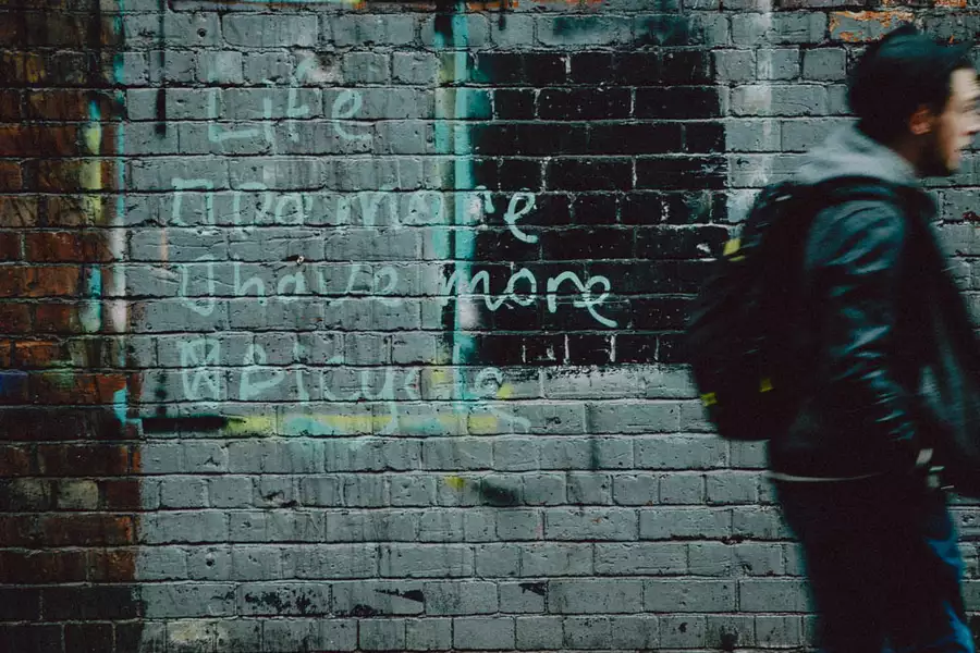 Graffiti on a brick wall that reads 'Life: Do More, Have More, Bicycle'