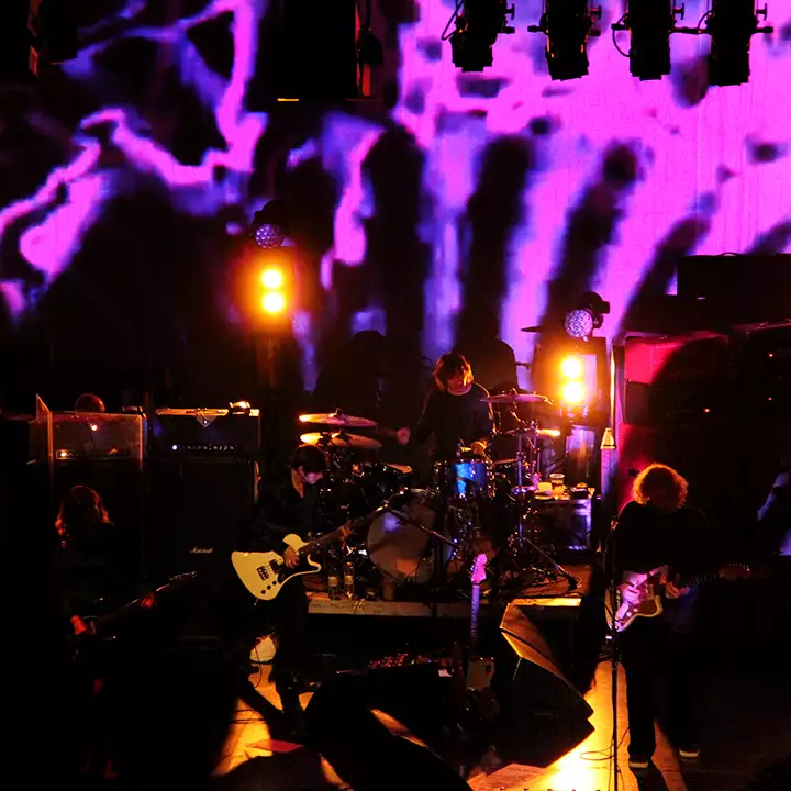 my bloody valentine perform live on a low lit stage