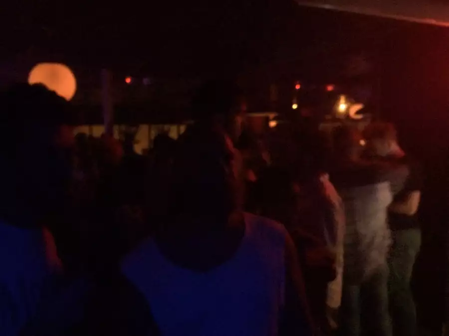 People on a dancefloor with a red spotlight