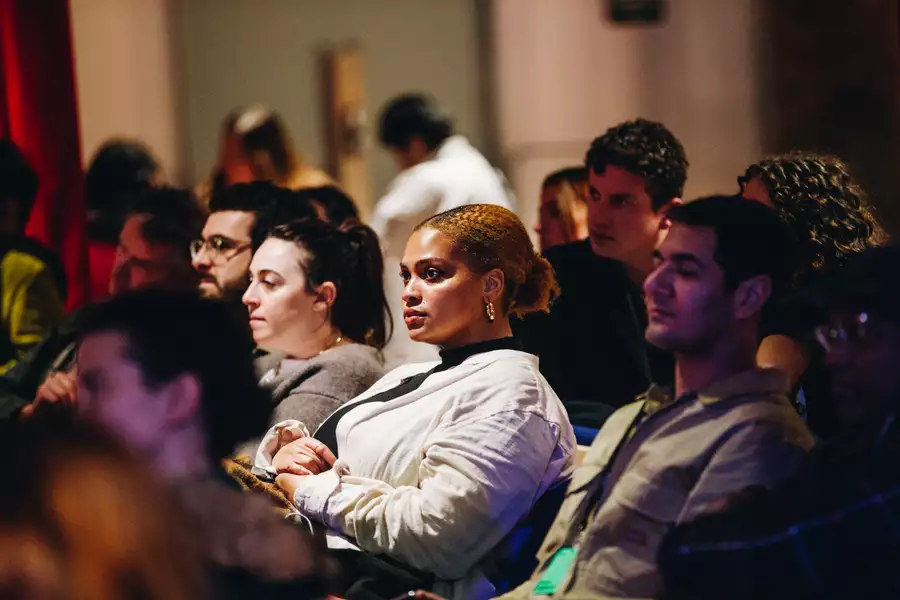 An audience shot of people watching