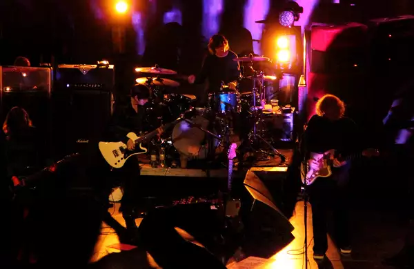 my bloody valentine perform live on a low lit stage