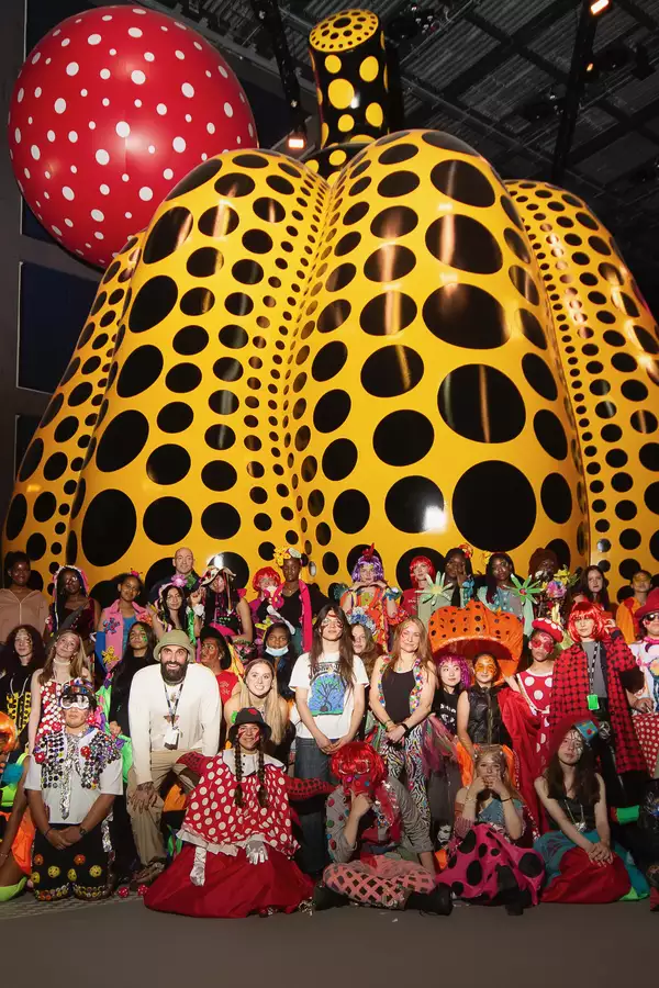 Image of a big group of people and children in the Kusama exhibition