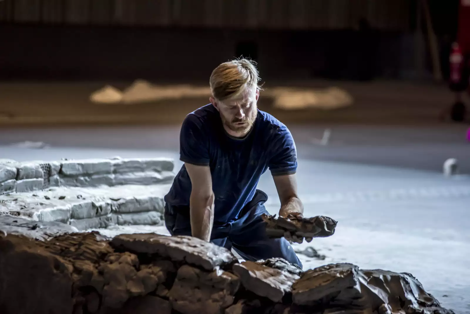 A performer building the clay installation during the June 2024 Artist Takeover