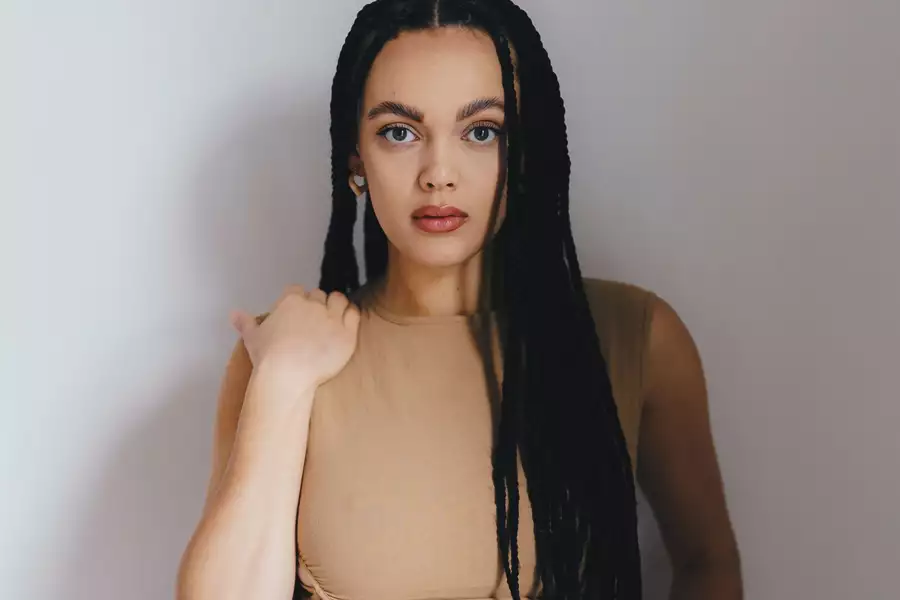 Portrait of Mali Hayes in a cream dress