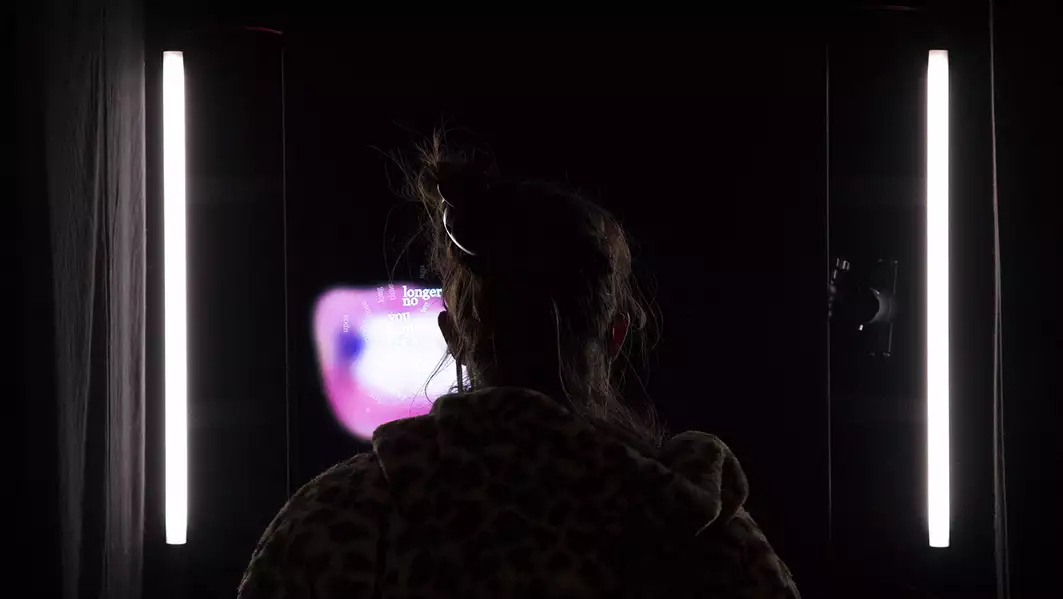 A person in a dark room looks at a lit up screen at UNC2021