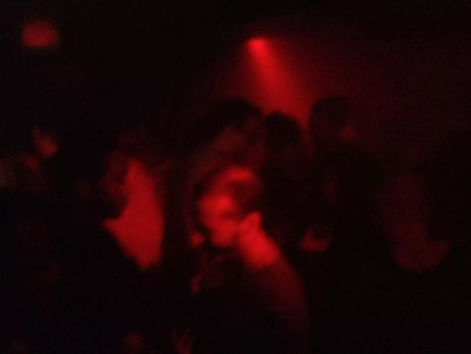 People on a dancefloor with a red spotlight